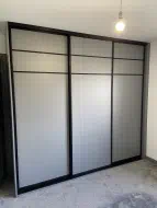 Light grey wood panels with 2 x one eighth strips at the top of the doors, fitted in Hartburn